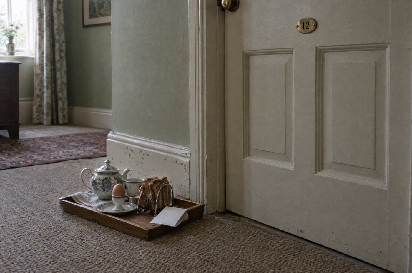 A breakfast tray left on the carpet outside room 12